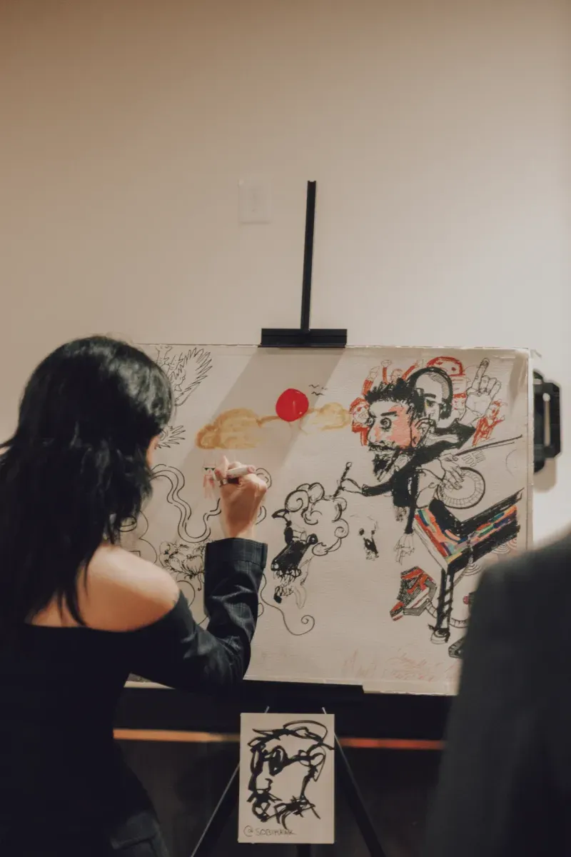 An artist painting live on a large canvas, Visionaries 2025
