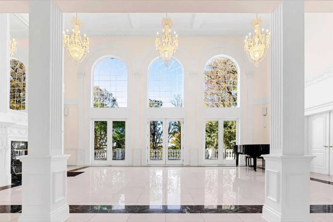 The grand ballroom at Beacon Hill Manor, with crystal chandeliers and arched windows