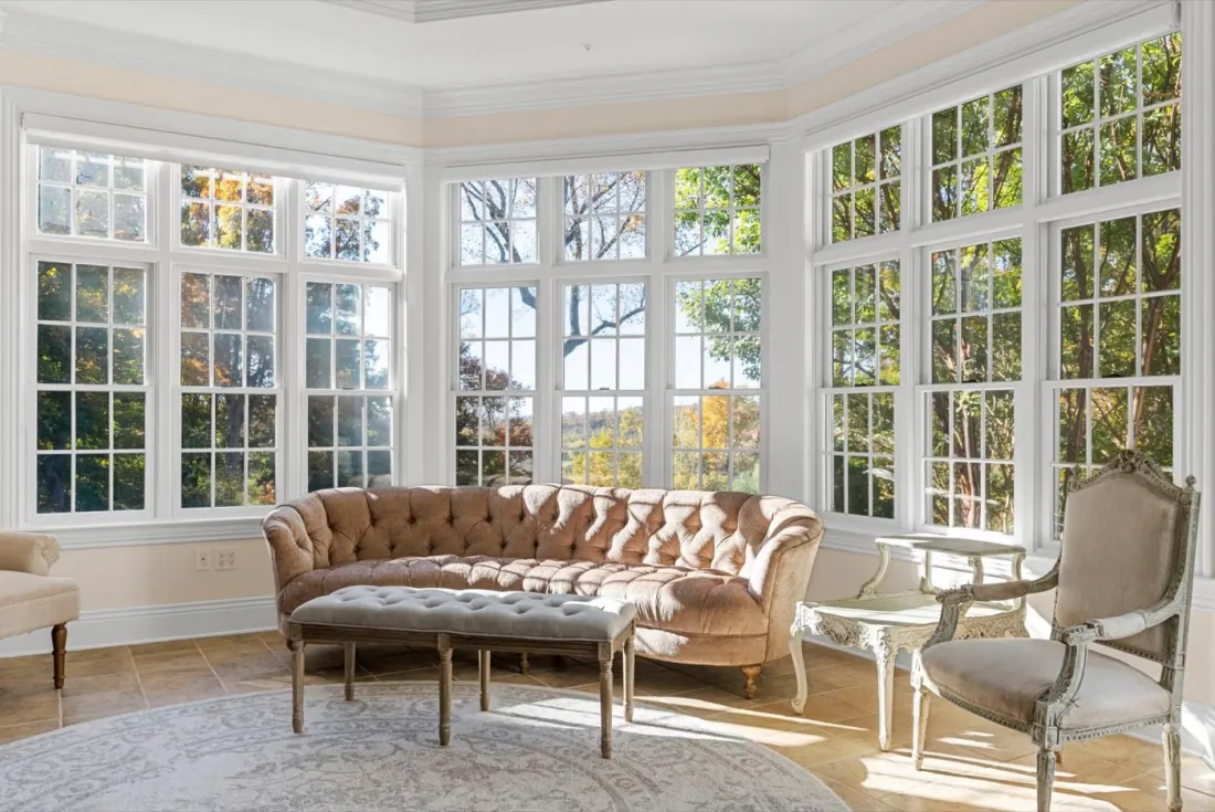 The sunroom at Beacon Hill Manor, wrapped in tall windows